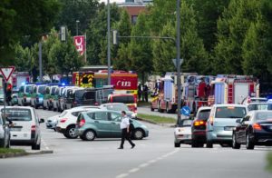 Police cars and fire trucks stand near a shopping centre in which a shooting was reported in Munich, southern Germany, Friday, July 22, 2016. Situation after a shooting in the Olympia shopping centre in Munich is unclear. (Matthias Balk/dpa via AP)