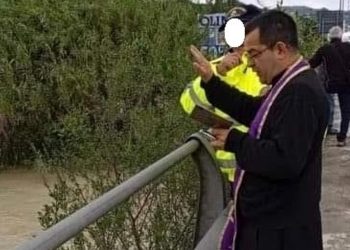 Il fiume è in piena e fa paura, don Gaston lo benedice: la suggestiva immagine diventa virale